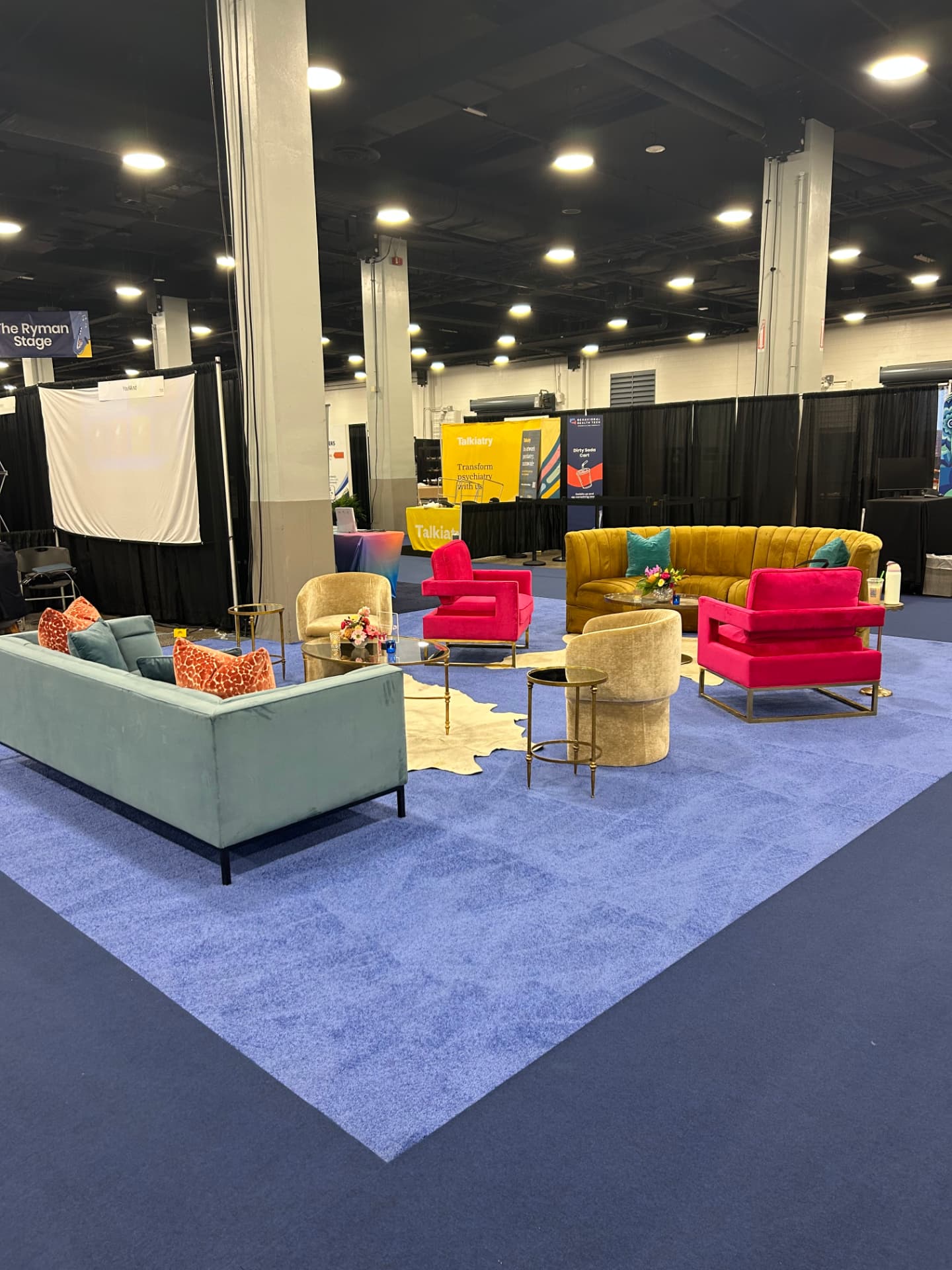 Lounge furniture on standard blue event carpet at a trade show